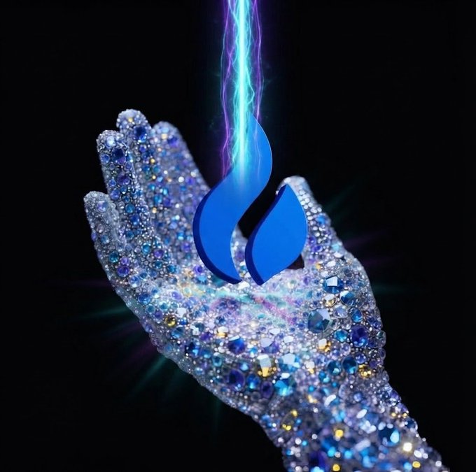 A glittering jewel-encrusted hand cradles a glowing blue flame in the shape of the Stocktwits icon, set against a dark background. The opulent, crystalline display visually embodies the "diamond hands" sentiment from the post, symbolizing a strong, unbreakable grip on a holding despite market fluctuations.