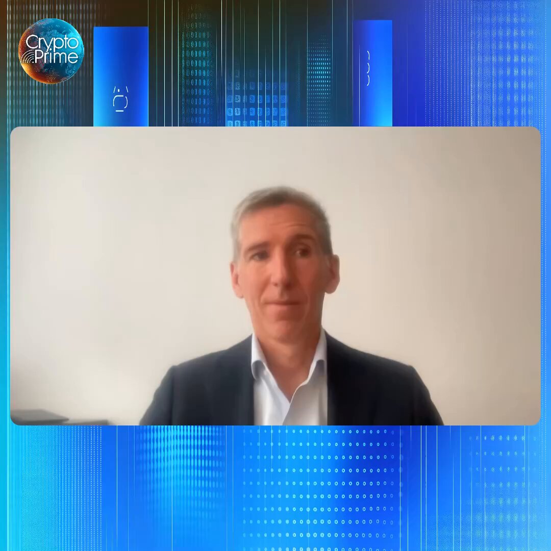The image features a man wearing a suit, sitting at a desk, and looking directly into the camera while talking on a computer screen. The background of the image has blue lines and dots that create an abstract pattern. The caption for the image reads "Great conversation with @NateGeraci. Good intro to Hyperliquid for advisors in particular."