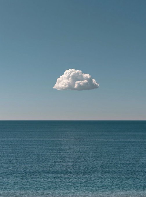 A minimalist image of a single, fluffy white cloud floating in a clear blue sky above a calm, dark blue ocean.