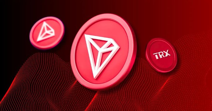 A 3D-rendered red coin featuring the TRX (TRON) logo and the text 'TRX' displayed against a dark red background with wave patterns.
