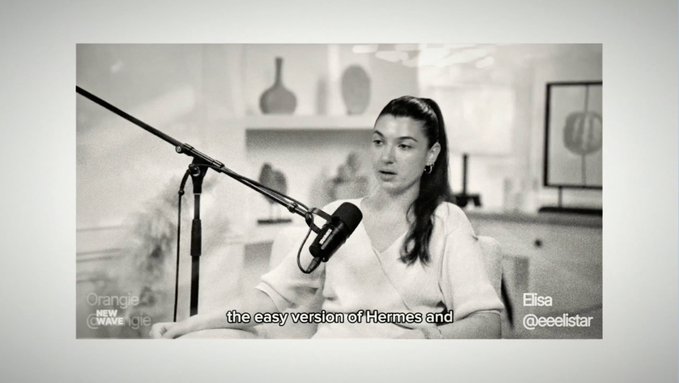A woman named Elisa (@ceelistar) is being interviewed on the "Orange Wave" podcast, with subtitles reading "the easy version of Hermes and." The image relates to the post by showcasing her podcast appearance with Jumper, which likely featured her story of creating an accessible version of the Hermes brand.