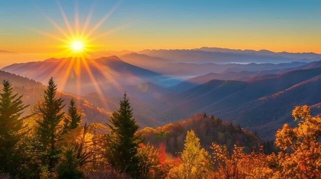 Sunrise over a mountainous forest landscape with autumn trees in the foreground.