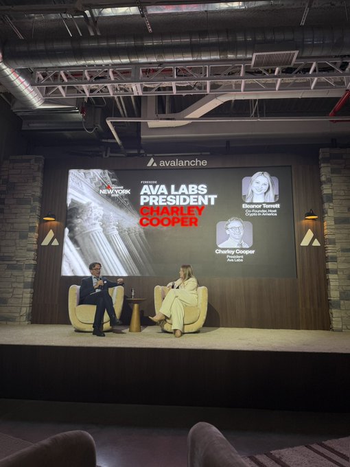An event stage featuring the Avalanche logo displays a presentation for 'AVA LABS PRESIDENT CHARLEY COOPER,' with a moderator and speaker seated in cream chairs in front of the screen.