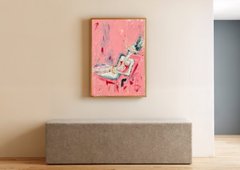 A minimalist room scene featuring a pink abstract painting hanging on a beige wall above a gray upholstered bench.