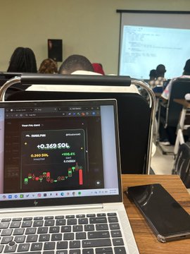 A laptop on a classroom desk displays a trading chart with "PUMP-PUMP" showing "+0.349 SOL" and "3,141 SOL" balance, while a smartphone sits beside it, humorously illustrating the post's point about prioritizing crypto gains over schoolwork.