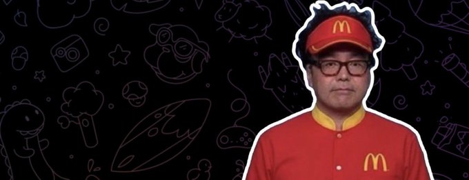 "eth" is written in a red font, which stands out against the black background of the image. This suggests that the image might be related to an advertisement or promotional material for the Mcdonald's restaurant chain. The presence of a person wearing a McDonald's uniform and hat further supports this idea.