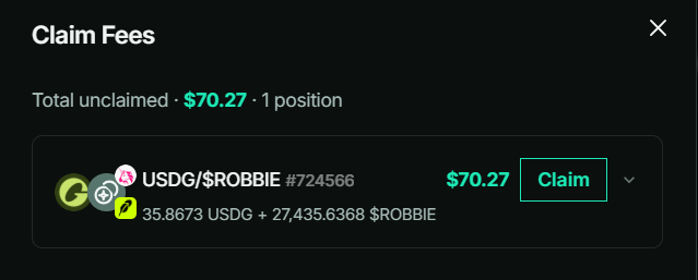 A dark-themed UI screen titled "Claim Fees" shows a total unclaimed amount of $70.27 for 1 position, with a specific entry for "USDG/$ROBBIE #724566" worth $70.27 (35.8673 USDG + 27,435.6368 $ROBBIE) alongside a green "Claim" button.