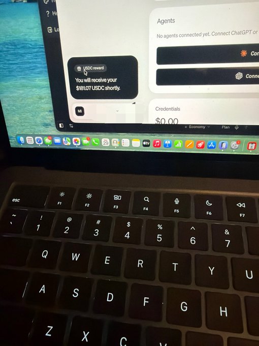A MacBook screen displays a payment interface showing a Coinbase notification claiming "You will receive your $13.07 USDC reward shortly," while the Moonpay-connected account shows a $0.00 balance—a likely reference to a delayed or failed payout. The image humorously underscores the post's frustration with Moonpay, contrasting the promised USDC reward with an empty wallet.