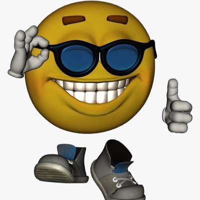 A smiling yellow emoji face wearing dark sunglasses, flashing an 'OK' hand sign with one hand and a thumbs-up with the other, positioned above a pair of grey slip-on shoes.