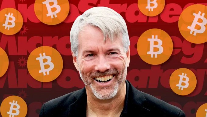 The image features a man with white hair wearing a black suit smiling for the camera while surrounded by numerous Bitcoin coins scattered around him. The text "MICROSOFT" can be seen, which might indicate that this event took place at Microsoft.