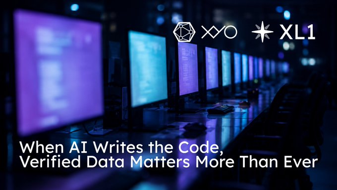 A row of glowing computer monitors in a dark server room displays lines of code, overlaid with logos for XYO and XL1 alongside the text "When AI Writes the Code, Verified Data Matters More Than Ever," reinforcing the post's message about the need for verifiable data as AI increasingly generates code like Coinbase's reported 95-100%.