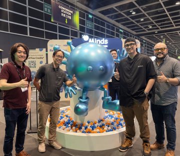 A group of men pose for a photo with a large, blue, cartoon-like mascot at an event, likely #LEAPeast in Hong Kong where "Bagyo.app" was presented to @animocabrands. The "Minds" logo is visible above the mascot.