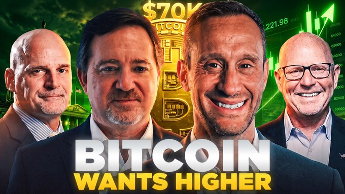 The image is a thumbnail promoting a YouTube video titled "BITCOIN WANTS HIGHER," featuring four men in business attire standing in front of a green Bitcoin graphic, a stock chart showing "221.98," and "$70K" text in the background. It visually ties to the post's discussion about why Bitcoin isn't falling despite expectations, with the bullish imagery and price reference reinforcing the video's optimistic stance on BTC's trajectory.