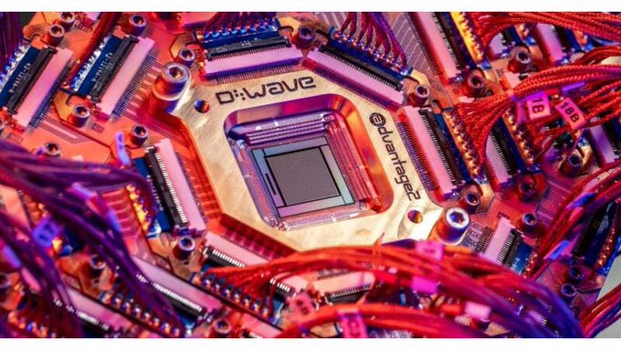 A close-up photo of a D-Wave Advantage quantum computing chip surrounded by red wiring and circuitry on its quantum processor.