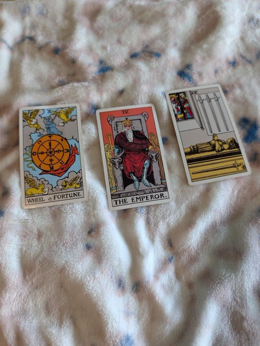 Three tarot cards—the Wheel of Fortune, The Emperor (IV), and the Four of Swords—rest on a fleece blanket, with their themes of destiny, authority, and rest humorously playing on the "$GAS" crypto ticker referenced in the post.