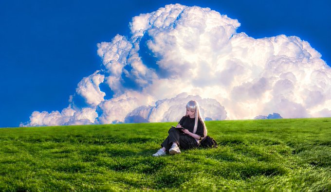 A person with long silver/blonde hair sits on a green grassy field looking at a phone, framed by the same dramatic billowing white cloud and green landscape as seen in image 4.