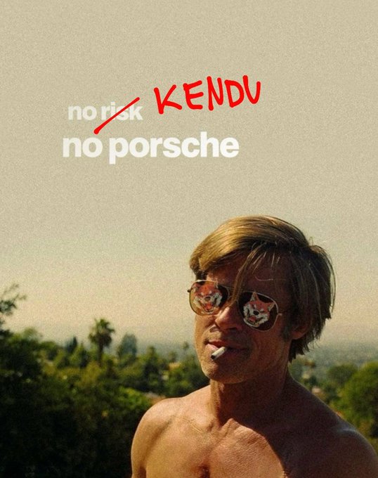 The image is a meme-style edit showing a man with sunglasses (featuring dog/animal reflections) and a cigarette, overlaid with modified text reading "no risk, no porsche" where "risk" is crossed out and replaced with handwritten red text spelling "KENDU." The visual plays on the popular "no risk, no reward" motivational phrase, linking the concept of taking a risk on the $KENDU memecoin to achieving a Porsche—reinforcing the post's message to manifest success by buying $KENDU now.