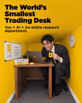 An advertisement image with the text 'The World's Smallest Trading Desk - You + AI = An entire research department' shows a man in a suit smiling at a laptop while holding a coffee mug in a tiny room.
