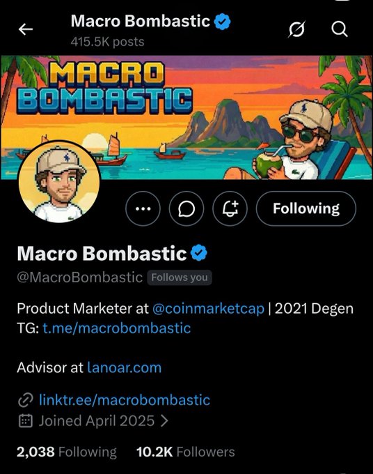 A screenshot of Macro Bombastic's X (Twitter) profile page (@MacroBombastic), showing 10.2K followers, 415.5K posts, and bio identifying him as a Product Marketer at @coinmarketcap and 2021 Degen, with a tropical-themed banner featuring a cartoon character with a coconut drink. The accompanying post by Dr. Nguyen gives a shoutout to this XRP OG and CoinMarketcap employee, encouraging others to follow him, which directly corresponds to the profile shown.