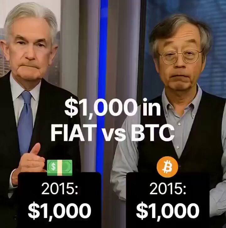 The image displays two men standing next to each other, both of them wearing suits with ties. One man has a thumbs-up sign near his face and is holding up some money worth $1,000. The other man has a Bitcoin logo on his shirt and appears to be engaged in conversation or explanation related to the concept of Bitcoins as an alternative currency for Fiat. Both men are dressed in business attire, suggesting that they might be discussing financial matters or economic trends.