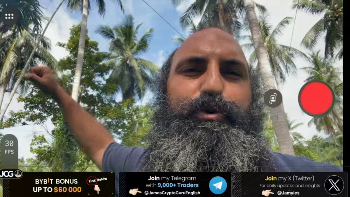 The image shows a man with a long beard standing outdoors, holding up his arm while looking at the camera. The background features palm trees, indicating that they are likely in a tropical or subtropical region. In the foreground of the photo, there is an advertisement for bitcoin dropping hits and another promotion related to the post on social media. These details suggest that the image might be promoting an online business or advertisement related to cryptocurrencies or Bitcoin drops. The man's presence near palm trees reinforces this theme, as these regions are known for their connection to the cryptocurrency market due to factors such as blockchain technology and mining activities.