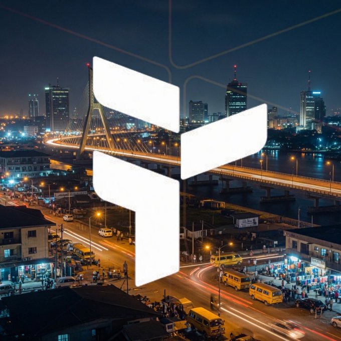 The image features a cityscape at night with tall buildings illuminated against the dark sky, creating an urban atmosphere. The main focus of the image is a white logo that reads "gTria" placed centrally within the frame. This logo represents the concept of mass adoption of Web3 technology and its potential impact on everyday users. The surrounding city lights and traffic create a sense of movement and dynamism in the scene, emphasizing the idea of progress and innovation.