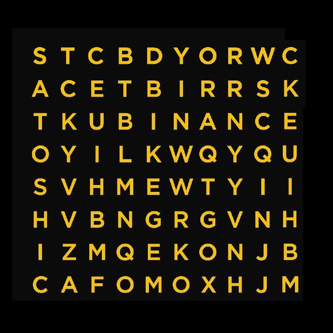 A word search puzzle with yellow letters on a black background, where 'BITMAP' and 'BINANCE' can be found spelled out diagonally in the grid.