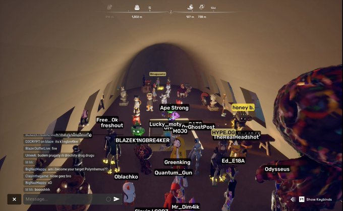 A crowded gathering of avatars gathers inside a dome-shaped structure in the metaverse game Otherside, with player names like "Ape Strong," "honey b.," "Greenking," "Quantum_Gun," "Oblachko," "Mr_Dim4ik," and "Odysseus" floating above the characters. The scene captures the virtual Odyssey adventure referenced in the post, showing participants assembled together in a cave-like environment while a chat window displays conversations about gaming, drugs, and Clavish rap.