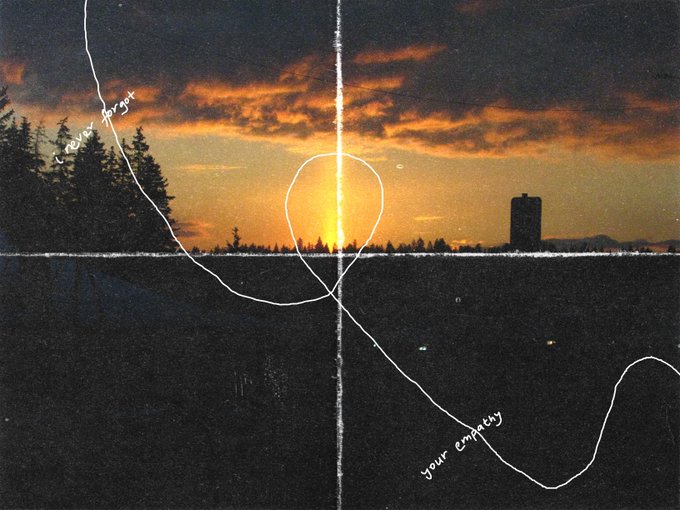 The image features an abstract art piece with a sunset scene, featuring a large sunburst shape that spans across the entire frame of the picture. The background includes trees and buildings, creating a serene atmosphere. The text "your empathy" is written in white cursive font at the bottom right corner of the image.