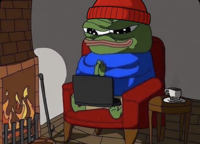A cartoon of the Pepe the Frog character wearing a red beanie and blue shirt, sitting in a red armchair by a fireplace while using a laptop.