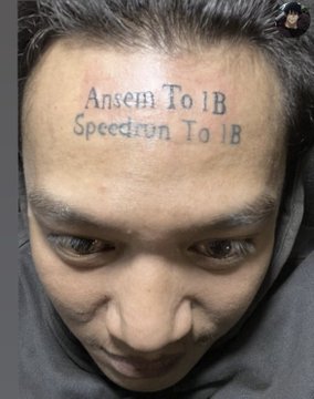 A young man with his head bowed, displaying a fresh forehead tattoo that reads "Ansem To 1B" on the top line and "Speedrun To 1B" below it, visually demonstrating his permanent commitment to the $ANSEM cryptocurrency project referenced in the caption.