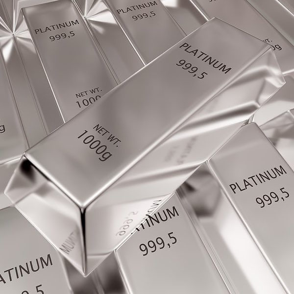A stack of silver-colored bars stamped "PLATINUM 999,5" with "NET WT. 1000g" markings, illustrating the real-world precious metal assets now being tokenized on the XRP Ledger and challenging traditional finance. The image visually reinforces the post's claim that real assets like platinum are moving onto blockchain rails, threatening Wall Street's dominance.