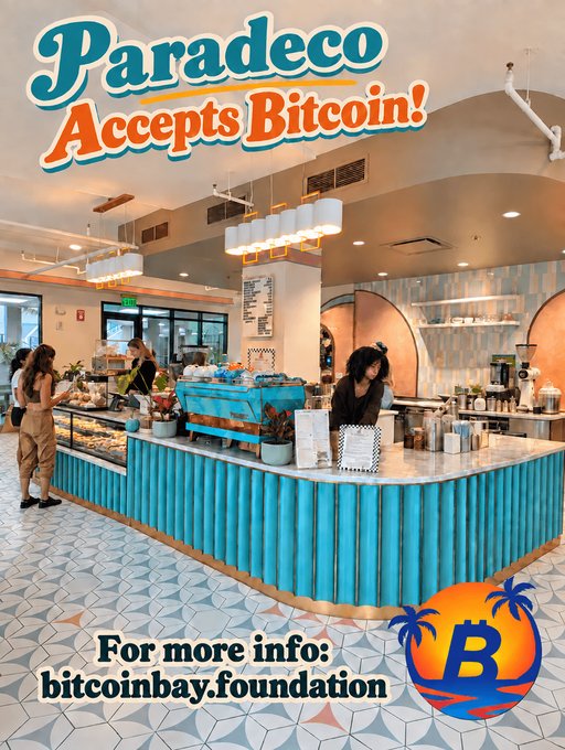 Promotional graphic reading 'Paradeco Accepts Bitcoin!' featuring the interior of a cafe with a barista at the counter, directing viewers to bitcoinbay.foundation with a Bitcoin logo.