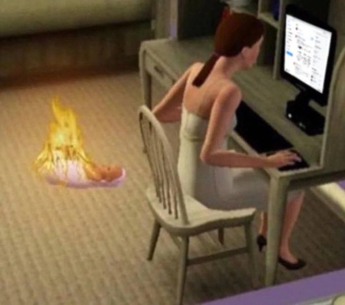 A woman from The Sims sits engrossed in her computer at a desk while her baby, engulfed in flames from its bassinet, burns on the floor behind her—perfectly illustrating the dark humor of the "Not now sweetie" caption as she ignores the tragedy to focus on minting.