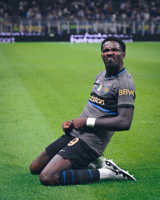A frustrated soccer player in a dark Inter Milan jersey featuring "BBVA" and "Pirelli" sponsorships kneels on the pitch with clenched fists and a grimace. The image's emotional intensity mirrors the betting context — capturing the anguish of an unlikely defeat that aligned perfectly for a 4-leg parlay at 4.20x odds, turning $100,000 into a $420,336 payout on Stake.