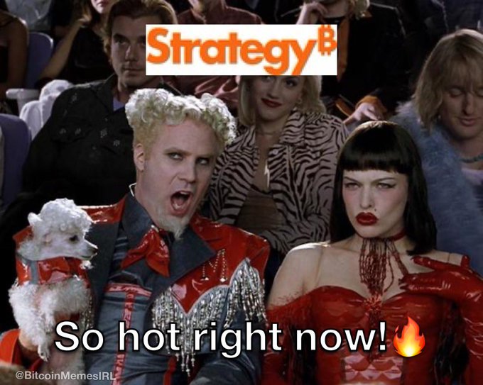 The image is a meme from Zoolander featuring Mugatu yelling excitedly at a fashion show while holding a small white poodle, with the "Strategy" logo (microstrategy style) placed at the top and the caption "So hot right now! 🔥" at the bottom. It humorously illustrates the post's enthusiasm about the upcoming massive $MSTY dividends, implying the yields are so attractive they're scorching hot right now.