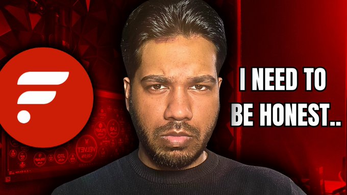A thumbnail featuring a man with a serious expression against a red background, with the text "I NEED TO BE HONEST.." prominently displayed next to him, alongside a red circular logo with a white design. The image relates to a video about the cryptocurrency $FLR, warning holders to watch the content for important information about the asset.