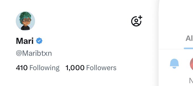 A Twitter profile for "Mari" (@Maribtxn) showing 410 Following and 1,000 Followers. The image captures her excitement at reaching the 1,000 follower milestone, with the verified blue checkmark beside her name and an avatar of a cartoon character with green hair and glasses.
