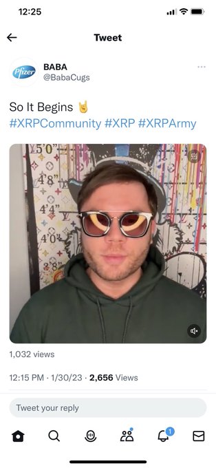 A Twitter/X mobile screenshot of a tweet from "BABA (@BabaCugs)" with a Pfizer avatar, captioned "So It Begins ✌️ #XRPCommunity #XRP #XRPArmy", featuring a video thumbnail of a man wearing sunglasses and a cap, showing 2,656 views from 1/30/23.