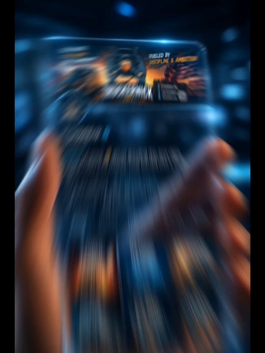 The image shows someone's hands holding a phone with a movie or game displayed on its screen. The person appears to be playing an interactive video game, as they are actively engaged with their device. The background of the image is dark blue, which contrasts with the bright colors and details of the phone screen.