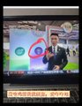 A television screen displays a news broadcast featuring a Pi Network promotional graphic, with the Pi logo visible alongside "Pi Network" text and news tickers at the bottom of the screen, aligning with the post's promotion of Pi Network as a global digital asset platform.