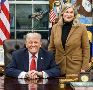 Donald Trump sits at his desk while Senator Cynthia Lummis stands beside him in the Oval Office. The image serves as a visual accompaniment to a post discussing the upcoming unveiling of the CLARITY Act and its application to crypto ethics rules.