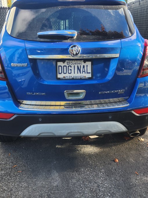 The rear of a blue Buick Encore SUV with a Quebec license plate reading 'DOGINAL'.