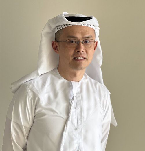The post continues but gets cut off mid-sentence at "The black"—likely referring to the black cord (agal) that holds the ghutra in place.

Here's a concise caption for the image:

**"A man wearing traditional Emirati attire, including a white Kandura (robe), a white Ghutra (headscarf) held in place by a black Agal (cord), illustrating the clothing explained in the post."**

This caption ties directly to the post's educational content about Gulf-region traditional dress, capturing all the key garments visible in the image.