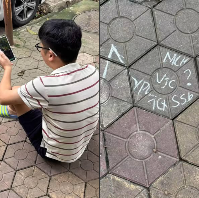 A split image shows a young man with glasses sitting on patterned pavement on the left, and chalk writing on hexagonal tiles on the right that reads "X MCH", "YD USC?", and "TG SSb".