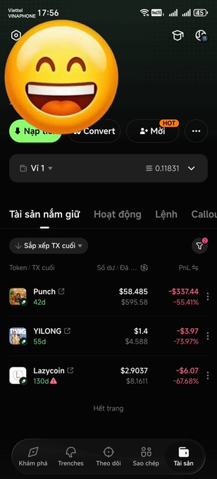 A mobile cryptocurrency trading app screen in Vietnamese showing a laughing emoji, with tokens like Punch, YILONG, and Lazycoin displaying significant price drops.