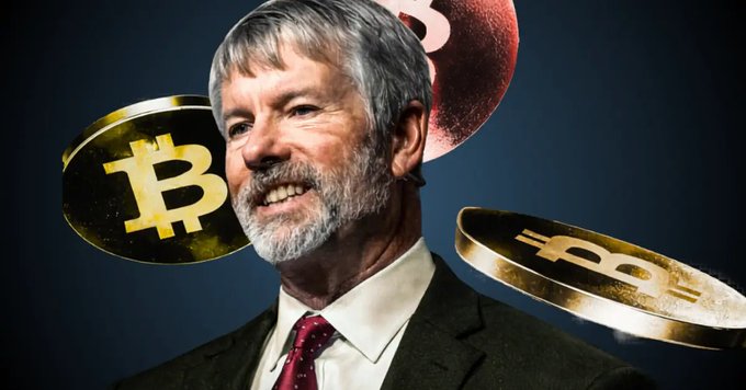 A man in a suit and red tie smiles in front of a dark background featuring floating Bitcoin tokens.