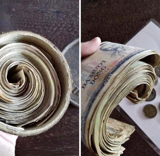 A rolled bundle of well-worn Vietnamese banknotes, including a "BẢY MƯƠI ĐỒNG" (70 đồng) bill, appears tightly coiled and aged—fitting the story of a grandfather's hidden stash from 1985 that left his descendants stunned to discover currency most younger generations have never seen.