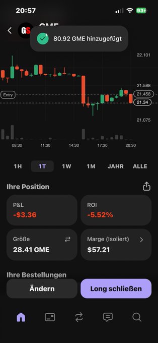 The image shows a phone screen that displays financial data, possibly stock price information for the GameStop cryptocurrency. The phone has an overlay of foreign text, which might be the language used by the user to access the data or display the results on their device.