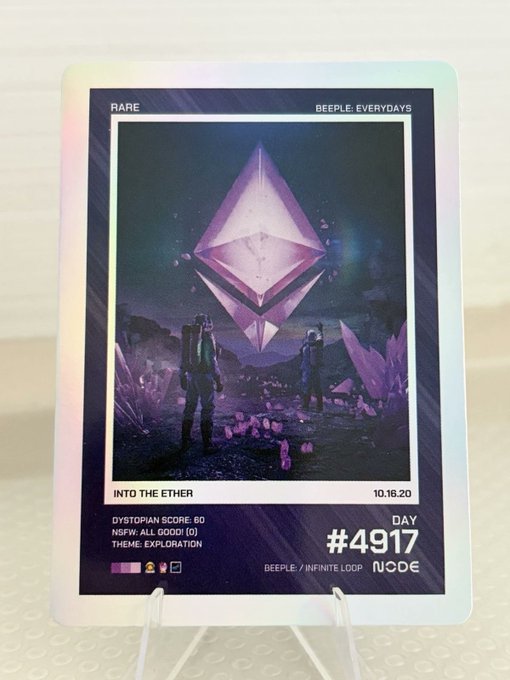 A holographic trading card labeled 'RARE' and 'BEEPLE EVERYDAYS' featuring artwork titled 'INTO THE ETHER' dated 10.16.20, showing two figures facing a large purple Ethereum crystal, with stats like 'DYSTOPIAN SCORE: 60' and '#4917'.